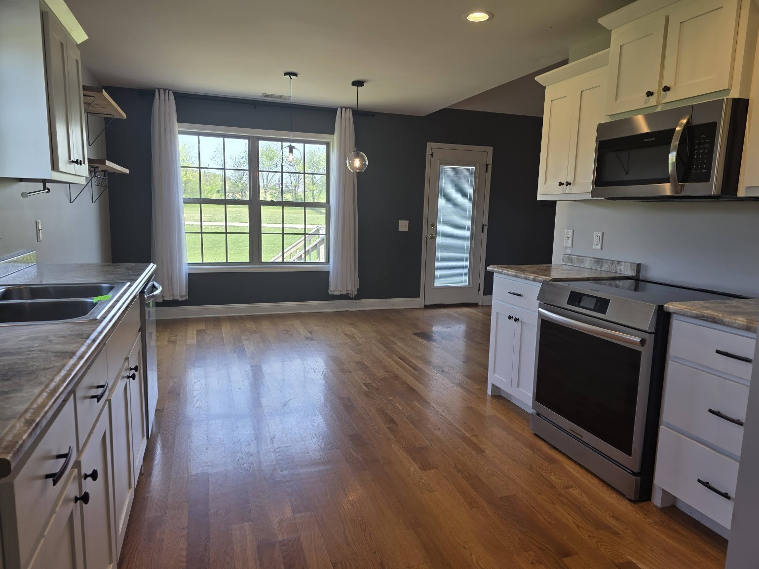 4927 Minnis Road Springfield, TN 37172 - Photo 5 of 15 a kitchen with stainless steel appliances wooden floors and a stove