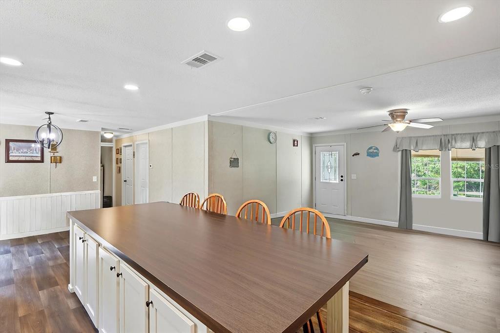 4801 North Mattox Point Crystal River, FL 34428 - Photo 14 of 46 a view of kitchen island a sink wooden floor and living room