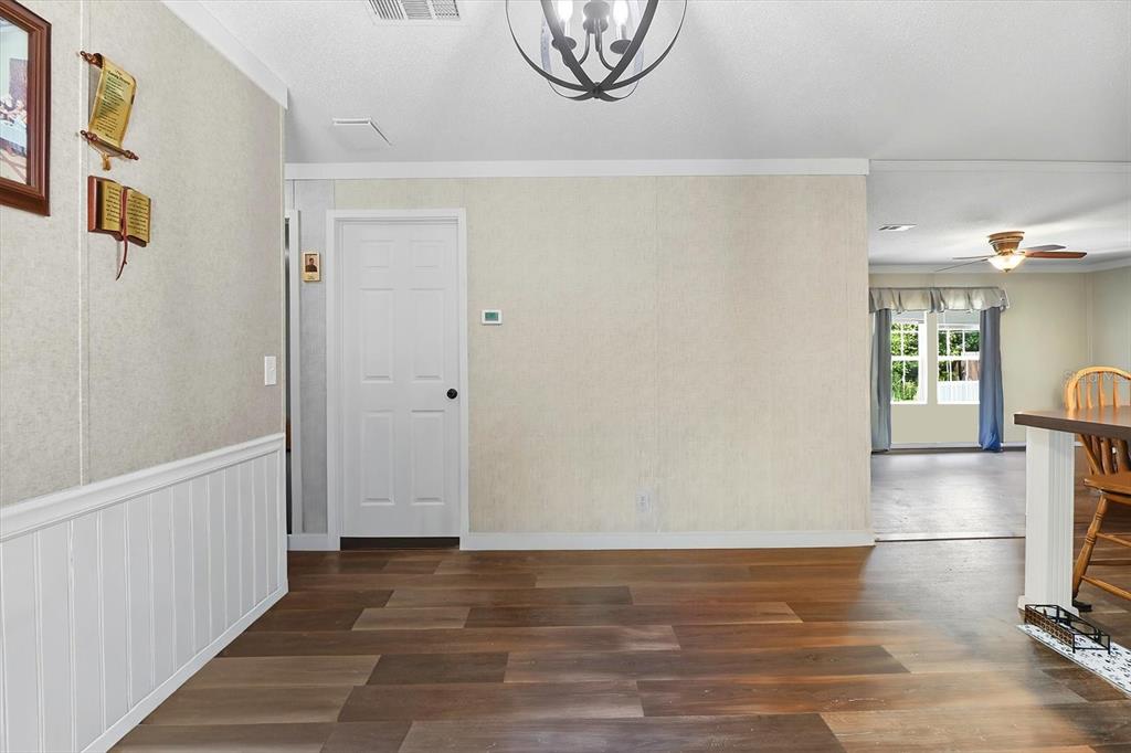 4801 North Mattox Point Crystal River, FL 34428 - Photo 22 of 46 a view of a livingroom with wooden floor and a chandelier