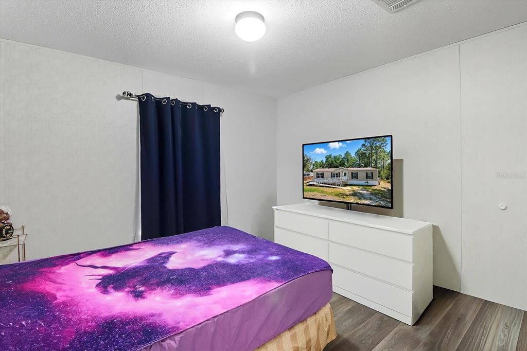 4801 North Mattox Point Crystal River, FL 34428 - Photo 28 of 46 a bedroom with a bed and a flat screen tv