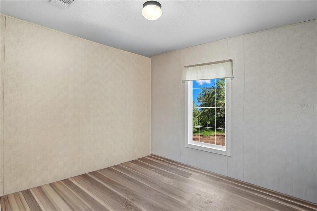 4801 North Mattox Point Crystal River, FL 34428 - Photo 32 of 46 wooden floor in an empty room with a window