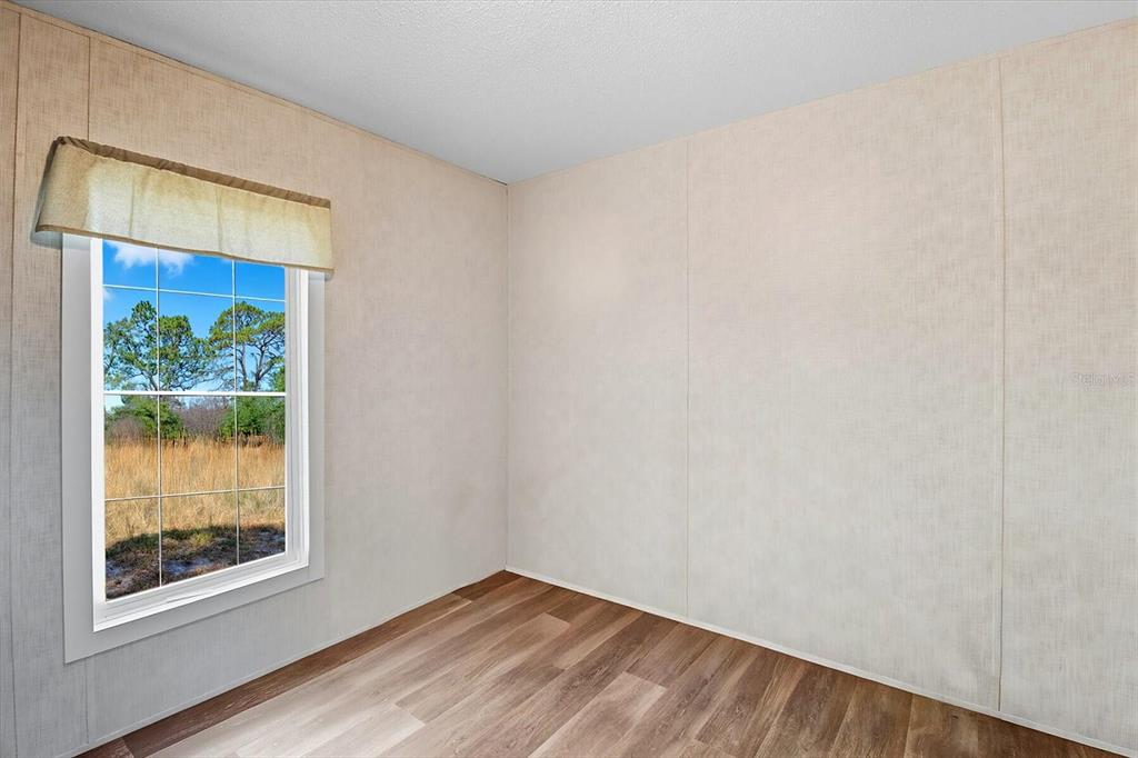 4801 North Mattox Point Crystal River, FL 34428 - Photo 34 of 46 a view of an empty room with wooden floor and a window