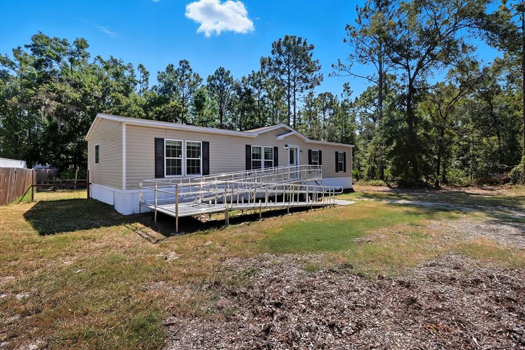 4801 North Mattox Point Crystal River, FL 34428 - Photo 10 of 46 a front view of a house with a yard and trees