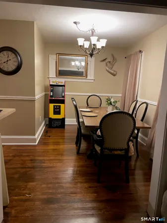 a view of a dining room with furniture and wooden floor