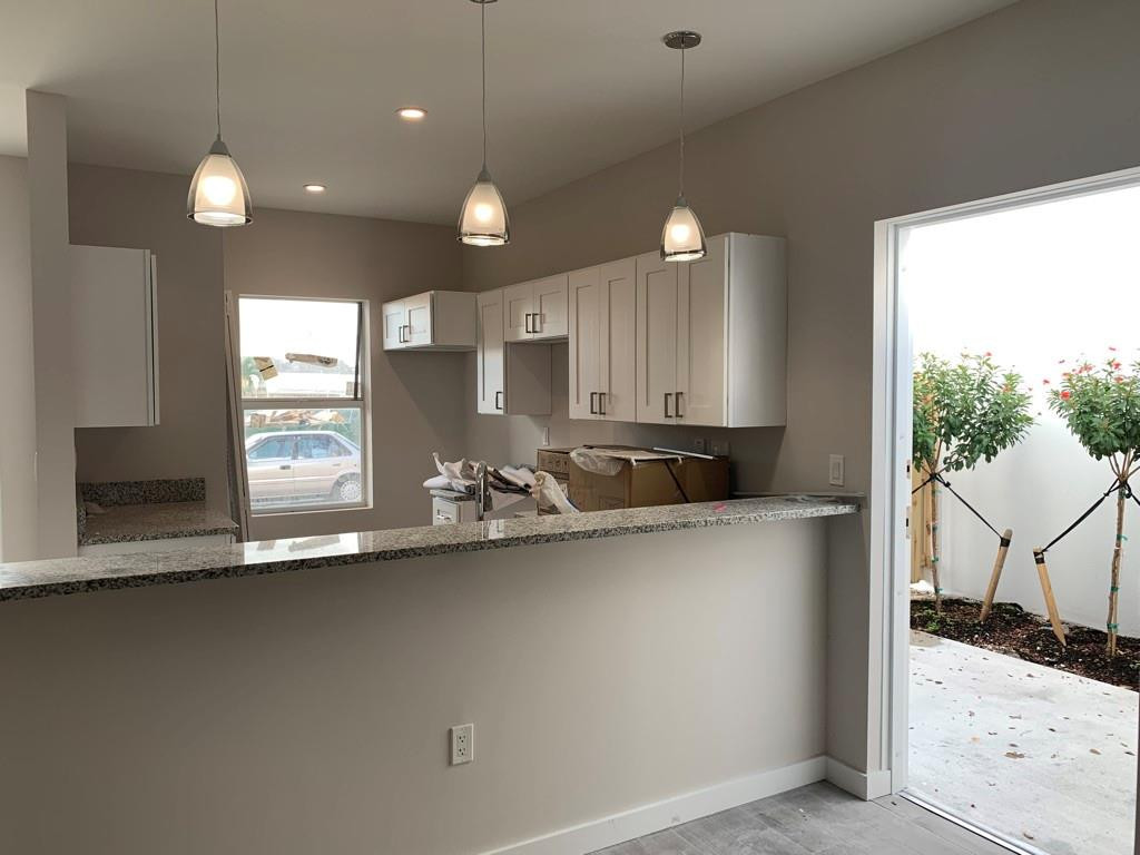 309 Foster Road, Unit 7 Hallandale Beach, FL 33009 - Photo 12 of 53 a kitchen with a sink a counter top space and appliances