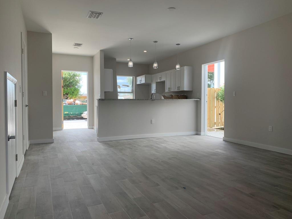 309 Foster Road, Unit 7 Hallandale Beach, FL 33009 - Photo 13 of 53 a view of empty room with wooden floor and window