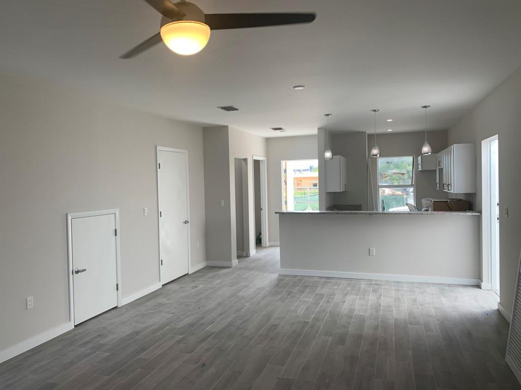 309 Foster Road, Unit 7 Hallandale Beach, FL 33009 - Photo 14 of 53 an empty room with wooden floor and windows