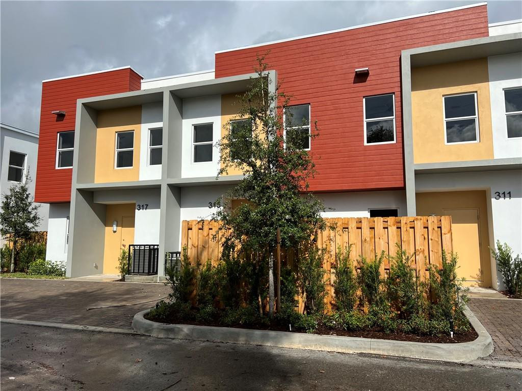 309 Foster Road, Unit 7 Hallandale Beach, FL 33009 - Photo 2 of 53 a front view of a house with a garden