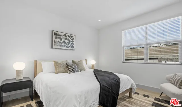 a bedroom with a bed and a lamp