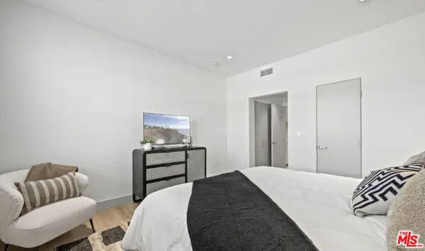 a bedroom with a bed and a couch