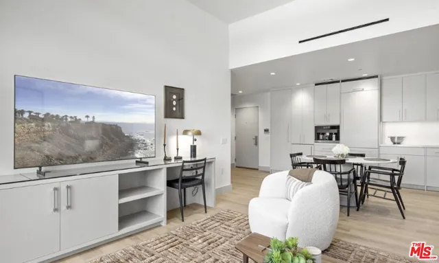 a living room with furniture a rug and white walls