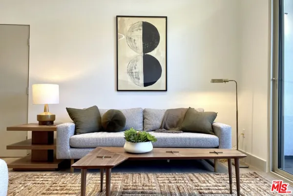 a living room with furniture and a mirror