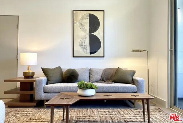 a living room with furniture and a mirror