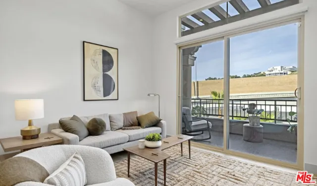a living room with furniture and a floor to ceiling window