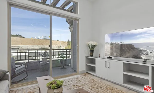 a outdoor space with a large window and furniture