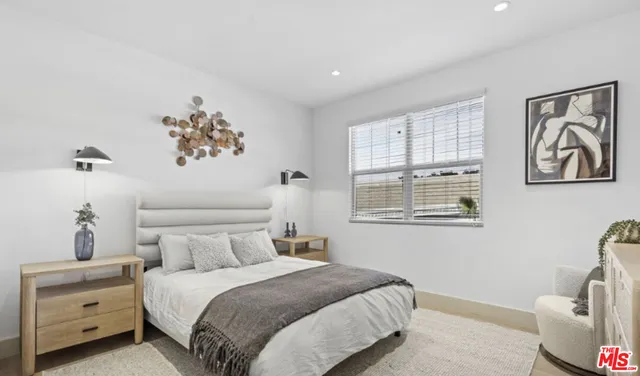 a bedroom with a bed and a painting on the wall