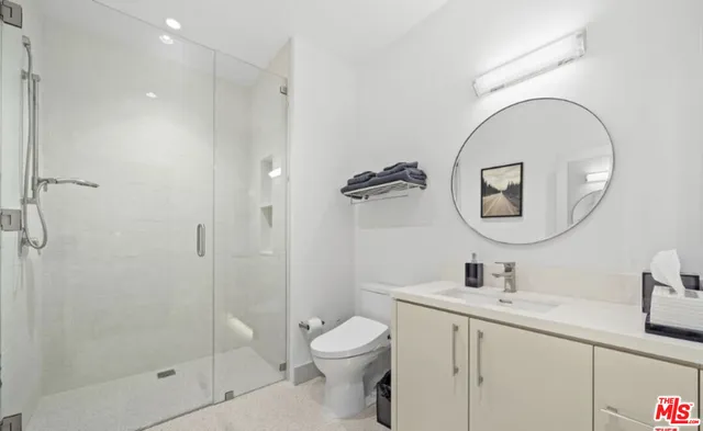 a bathroom with a toilet sink and a mirror
