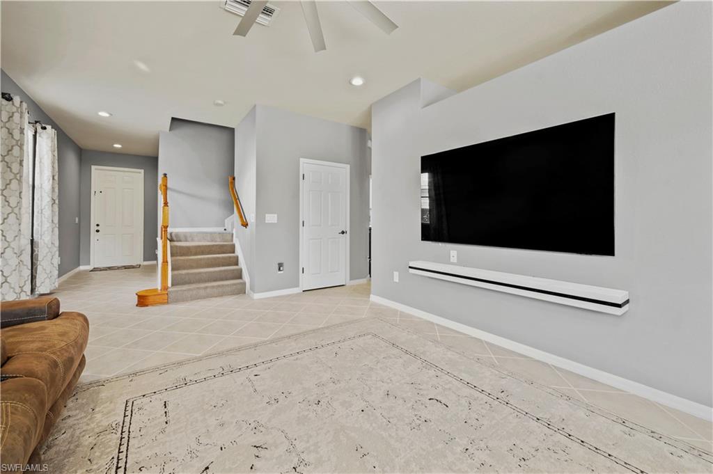 20686 Larino Loop Estero, FL 33928 - Photo 13 of 47 a living room with a flat screen tv and white walls