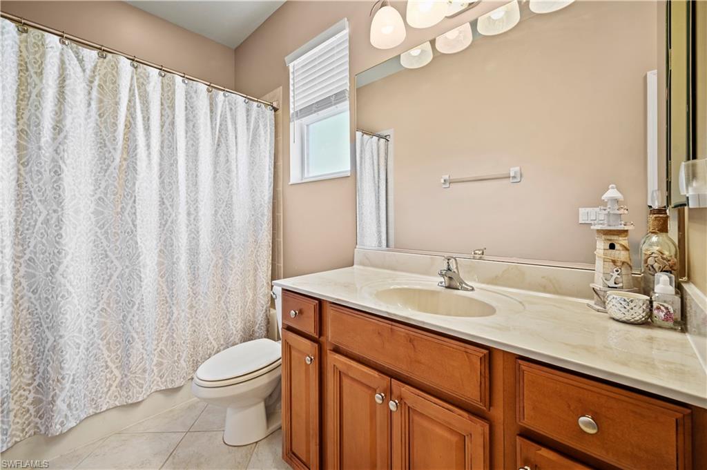 20686 Larino Loop Estero, FL 33928 - Photo 24 of 47 a bathroom with a granite countertop sink and a mirror