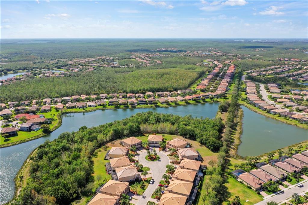 20686 Larino Loop Estero, FL 33928 - Photo 4 of 47 an aerial view of a city with lots of residential buildings lake and ocean view