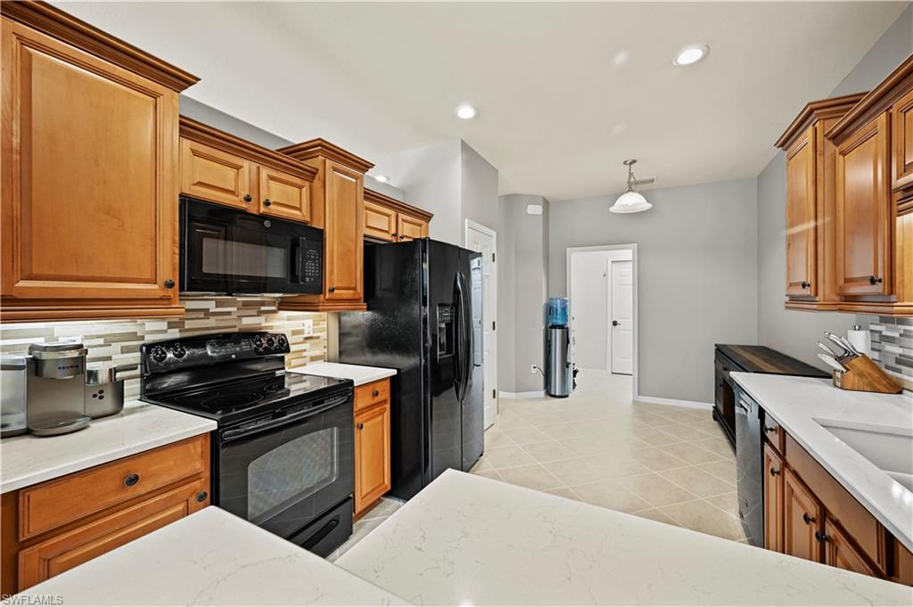 20686 Larino Loop Estero, FL 33928 - Photo 6 of 47 a kitchen with a sink stove and refrigerator