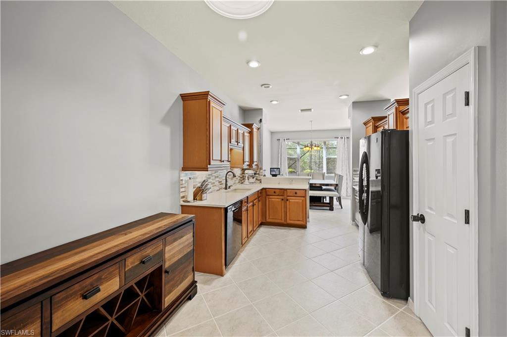20686 Larino Loop Estero, FL 33928 - Photo 8 of 47 a kitchen with stainless steel appliances a sink stove and refrigerator