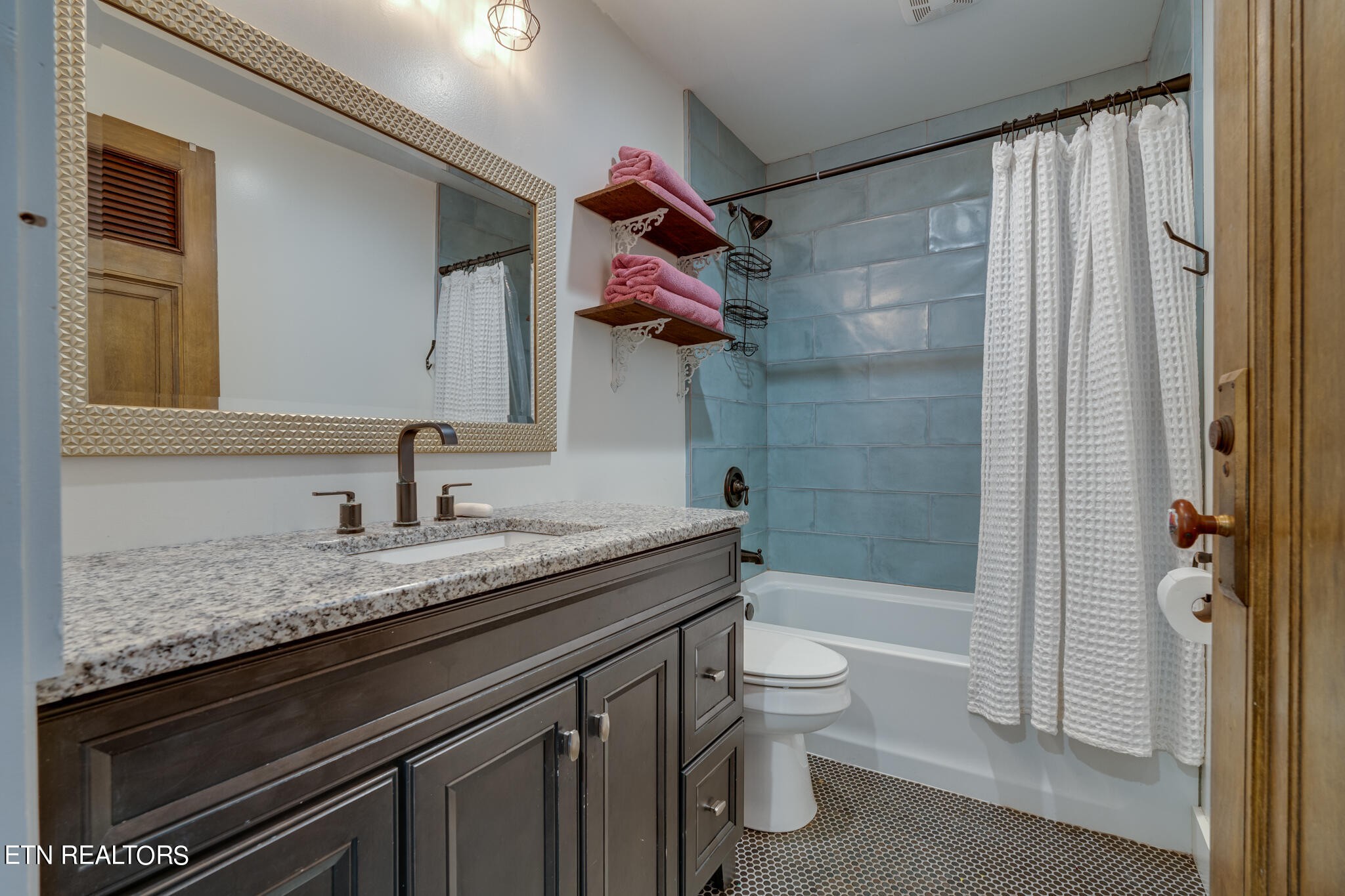 818 McCammon Road Knoxville, TN 37920 - Photo 11 of 60 a bathroom with a granite countertop sink toilet and shower