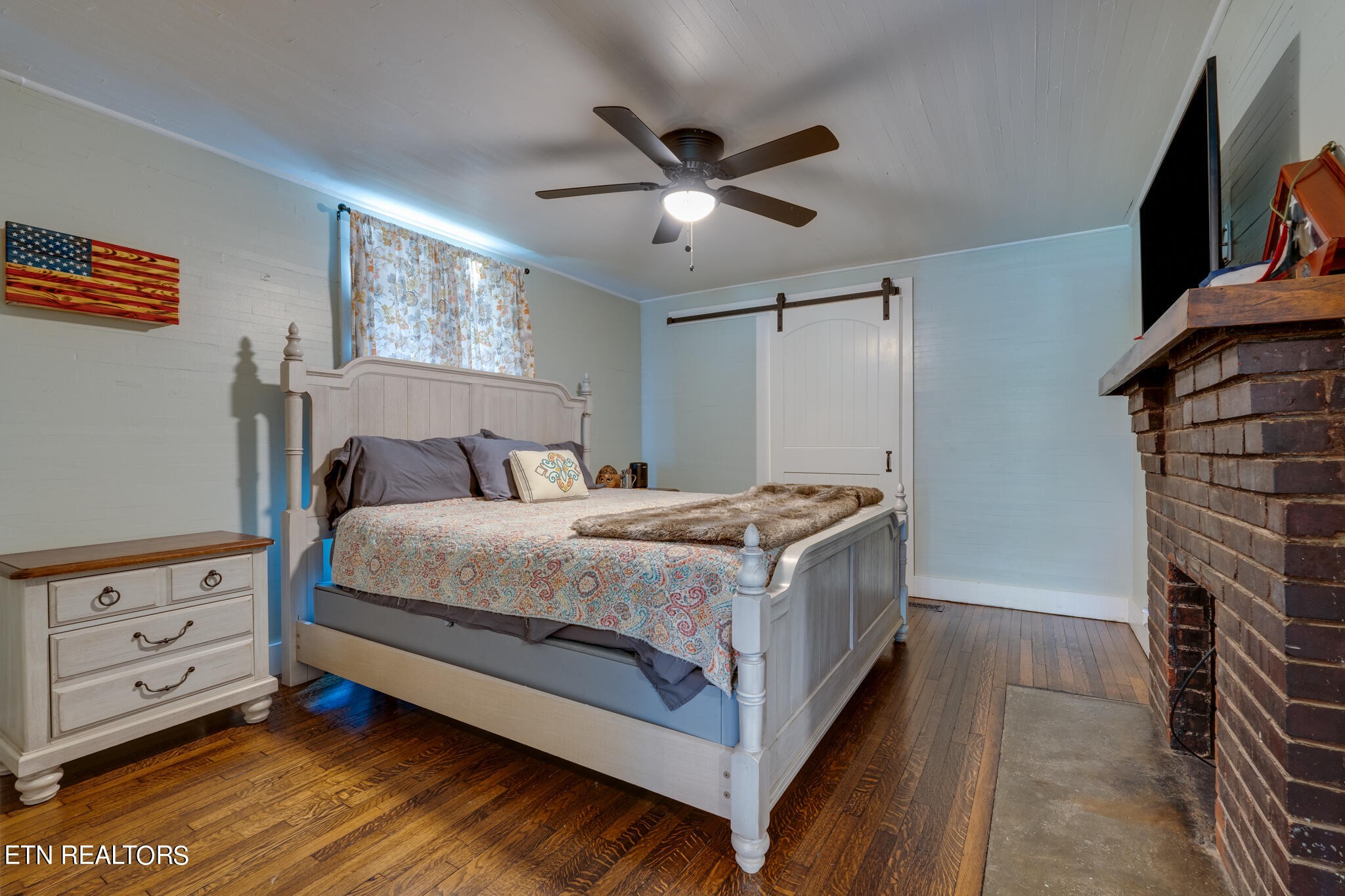 818 McCammon Road Knoxville, TN 37920 - Photo 17 of 60 a bedroom with a bed and a flat tv screen on the dresser