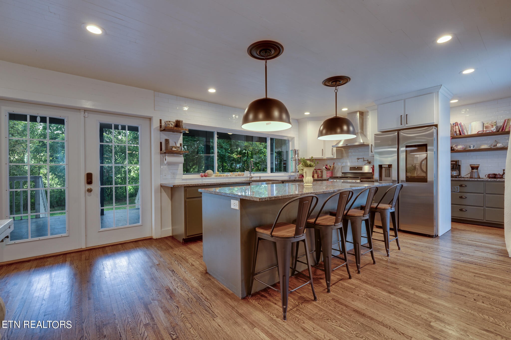 818 McCammon Road Knoxville, TN 37920 - Photo 3 of 60 an open kitchen with wooden floor and stainless steel appliances