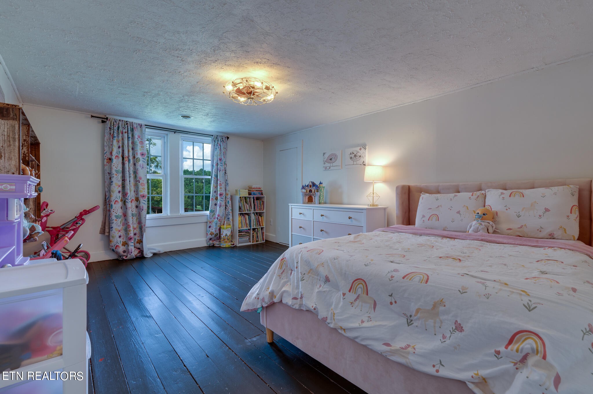 818 McCammon Road Knoxville, TN 37920 - Photo 34 of 60 a spacious bedroom with a bed and a wooden floor