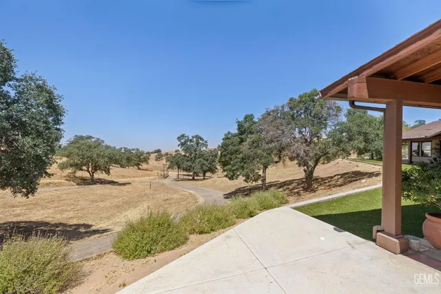a view of a house with backyard porch and sitting area