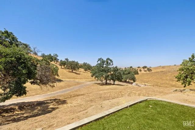 a view of a hallway with furniture and a window