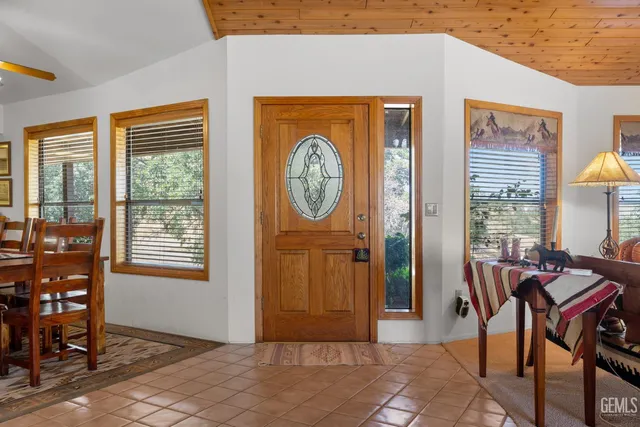 a living room with furniture a window and a dining table with wooden floor