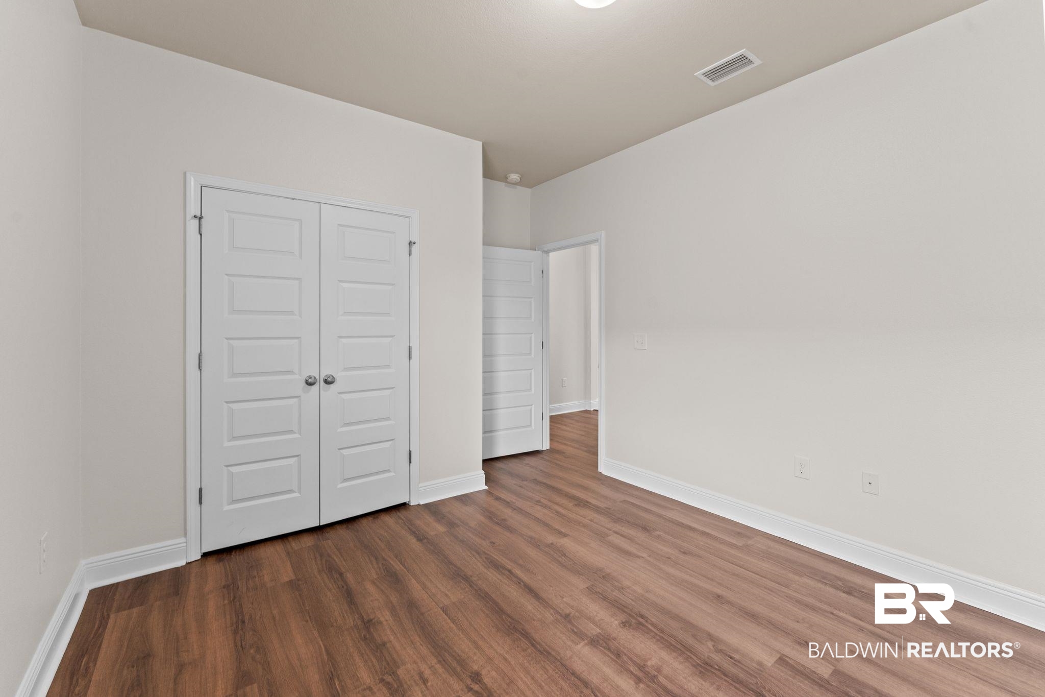 1464 Surrey Loop Foley, AL 36535 - Photo 18 of 24 Unfurnished bedroom featuring wood finished floors and a closet
