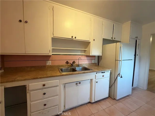 a kitchen with appliances cabinets and a sink