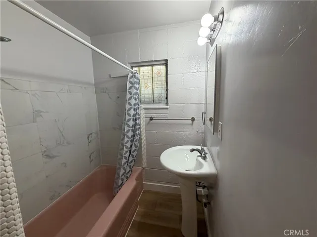 a bathroom with a sink a mirror and a bathtub
