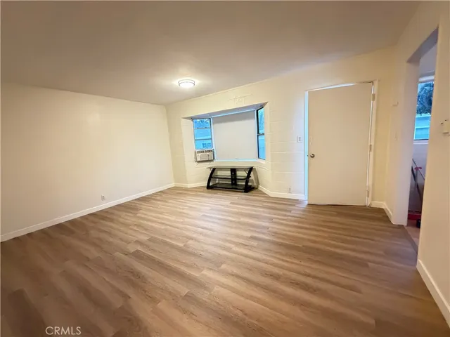 a view of a room with wooden floor