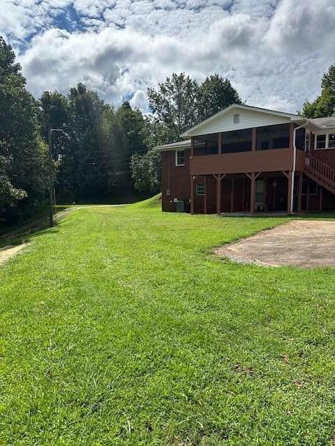 1323 Cavender Creek Road Dahlonega, GA 30533 - Photo 39 of 56 a house with huge green field in front of it