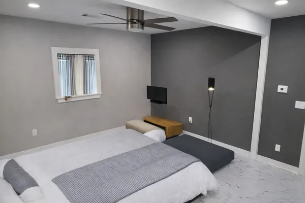 a bedroom with a bed and a night stand