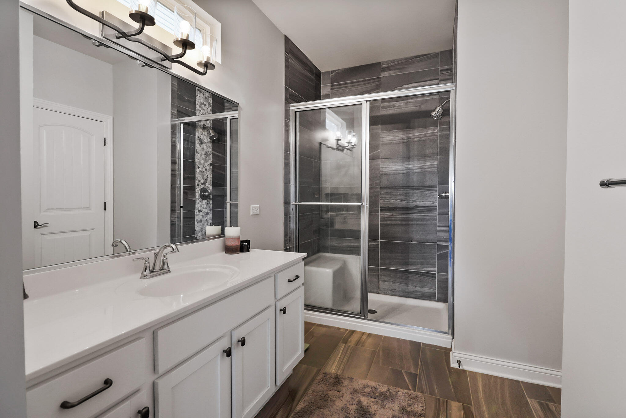 10188 Azalea Drive Crown Point, IN 46307 - Photo 15 of 29 a bathroom with a shower sink and mirror