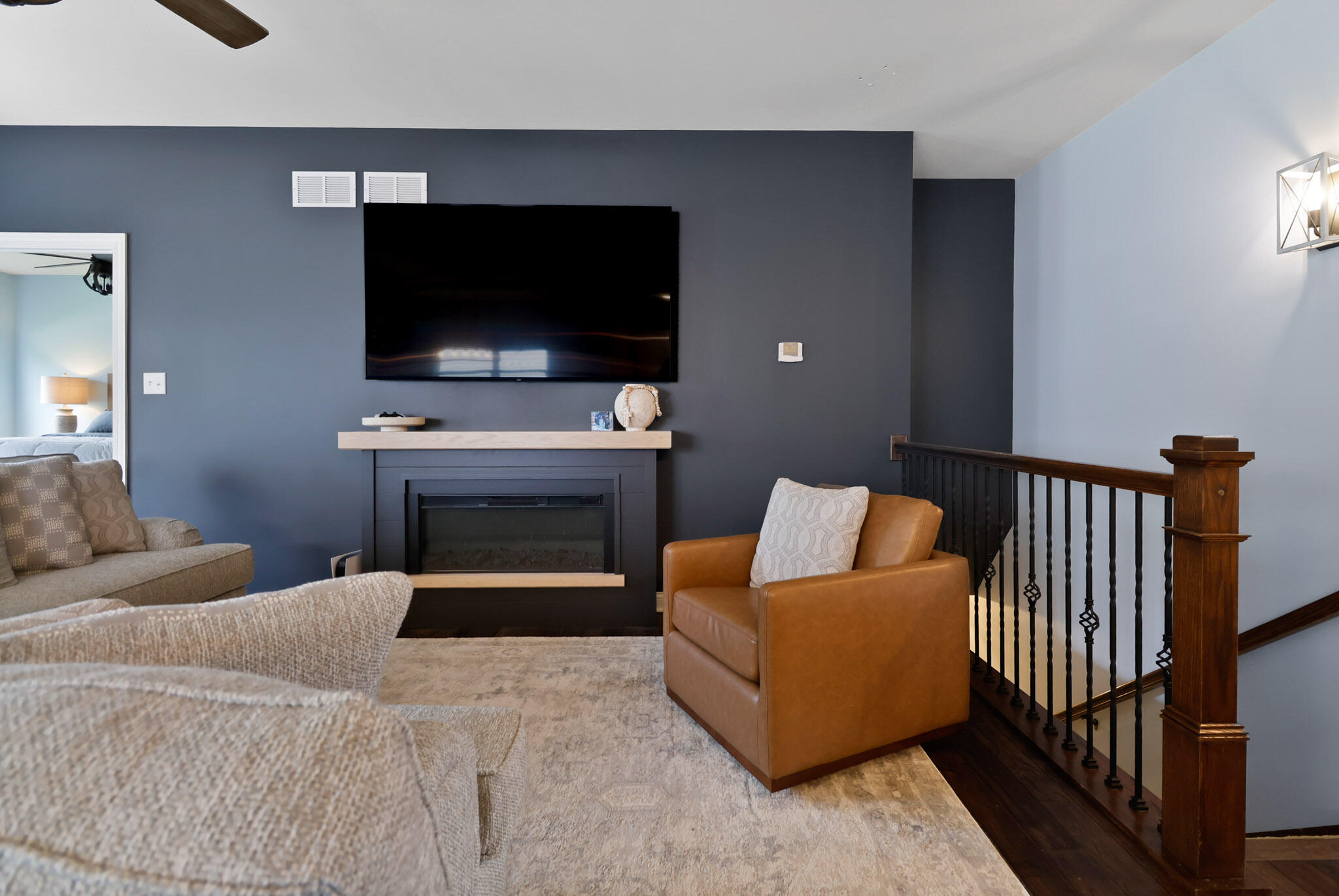 10188 Azalea Drive Crown Point, IN 46307 - Photo 7 of 29 a living room with a fireplace and a flat screen tv