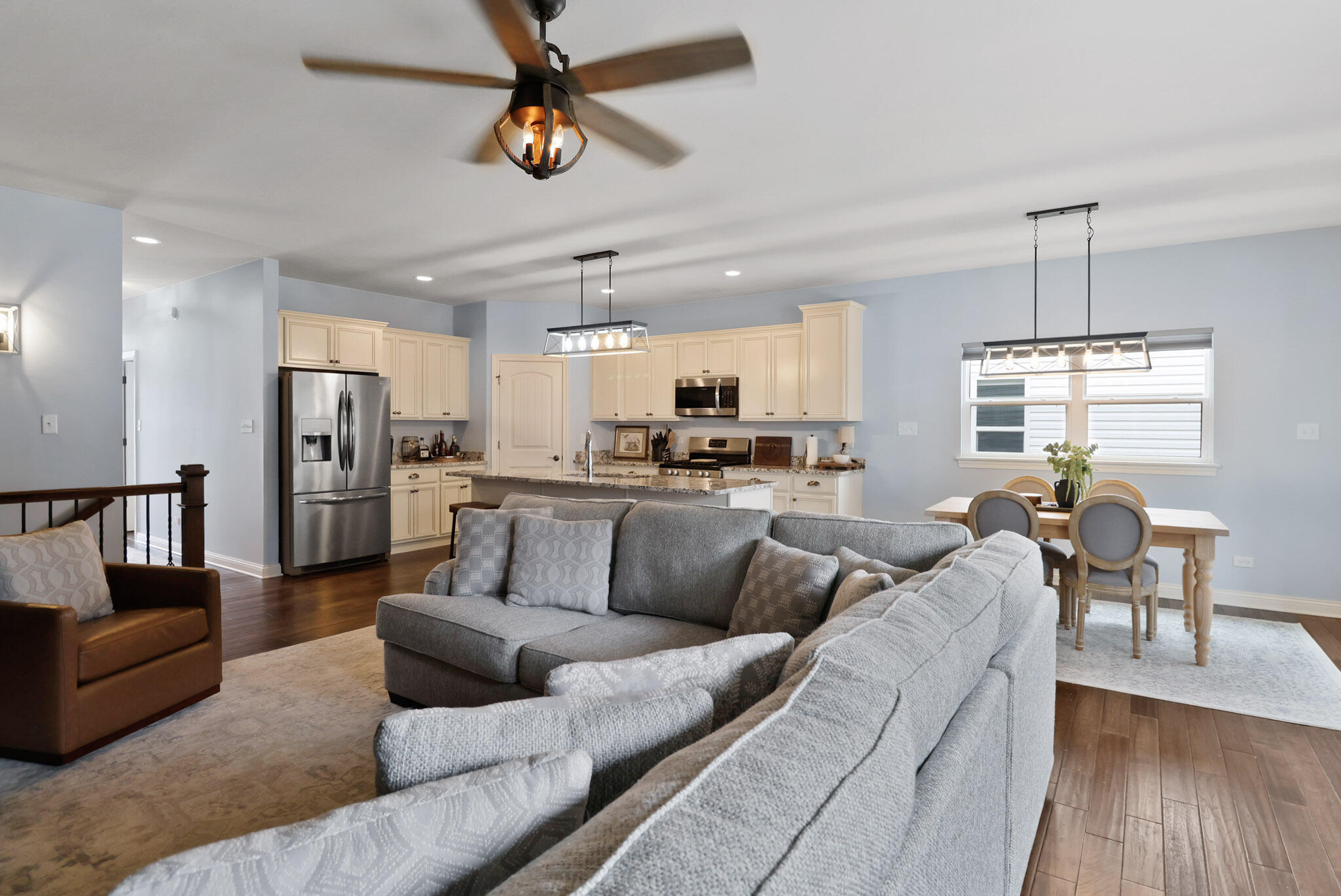 10188 Azalea Drive Crown Point, IN 46307 - Photo 10 of 29 a living room with furniture kitchen view and a wooden floor