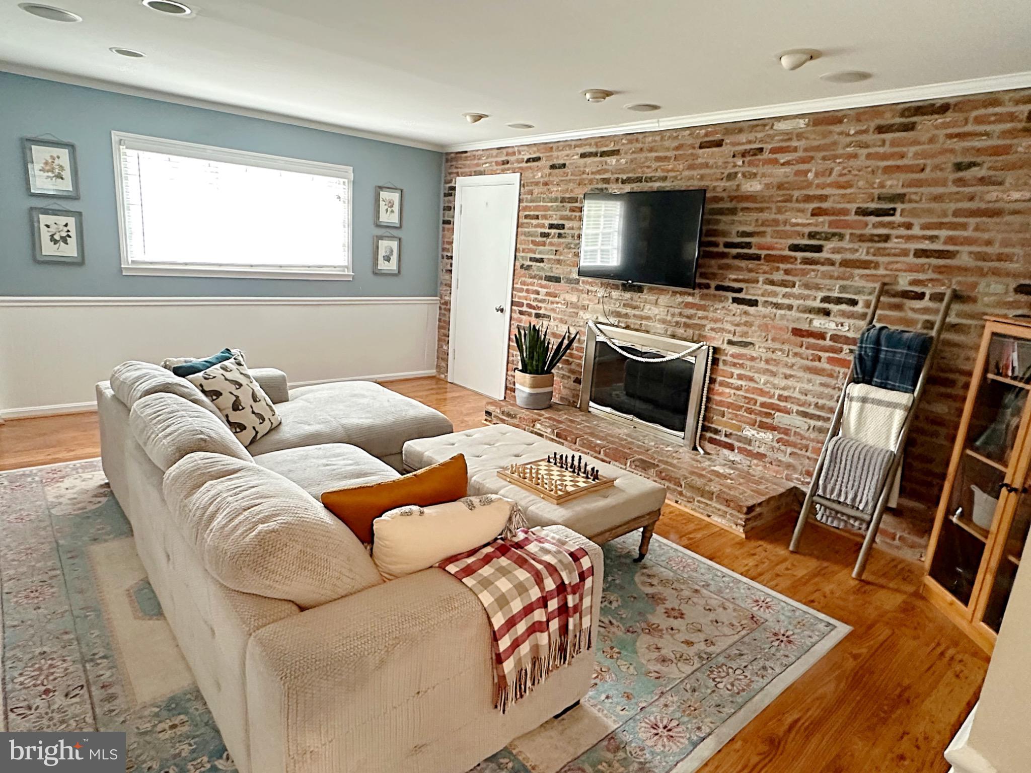 422 Old Courthouse Road Northeast Vienna, VA 22180 - Photo 5 of 25 Charming living space with rustic brick accents.