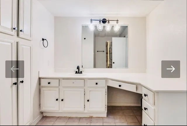 a bathroom with a double vanity sink a mirror and a bathtub