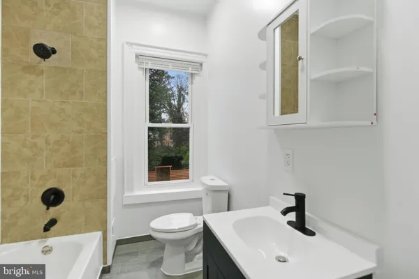 a bathroom with a bathtub and window