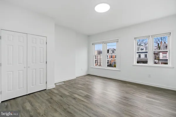 a view of a room with wooden floor