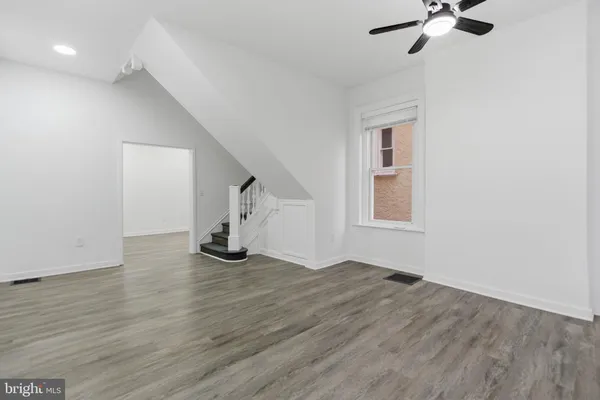 a kitchen with stainless steel appliances a stove a sink a microwave a refrigerator and cabinets