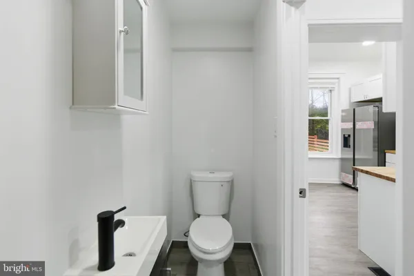 a view of staircase with wooden floor and white walls