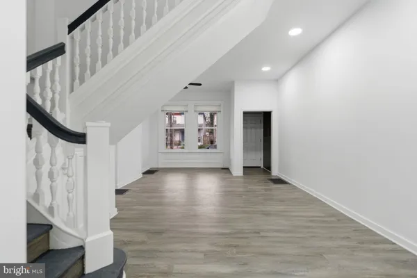 a view of entryway and hall with wooden floor