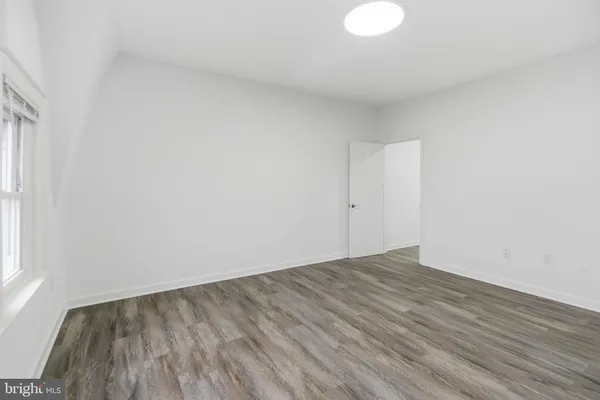 a view of a room with wooden floor and a sink